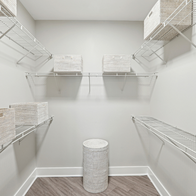 Porter Westside - Apartments in Atlanta, GA - A spacious walk-in closet featuring organized baskets and shelves for storage